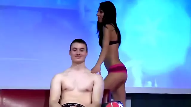 Attractive stripper massages a guys cock on the stage