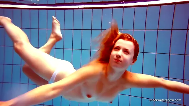 In The Indoor Pool, A Stunning Girl Swims