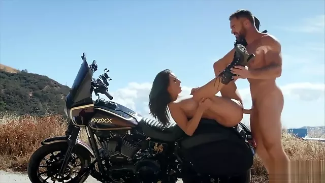 Pumping cock into Ashley Adams outdoors on a motorbike