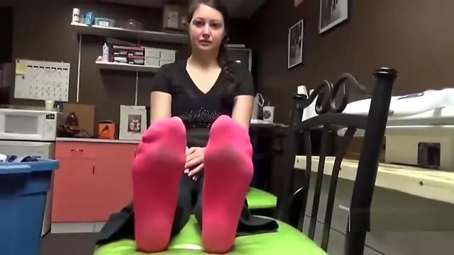 Brunette girl takes off her socks to show these pretty feet